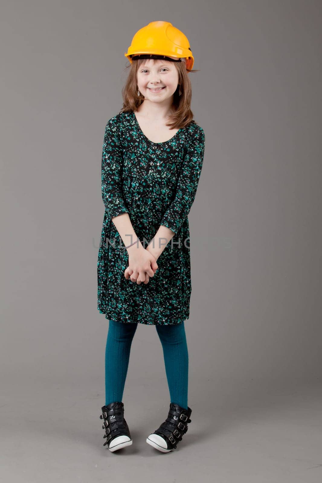 young happy girl.  little girl on a gray background