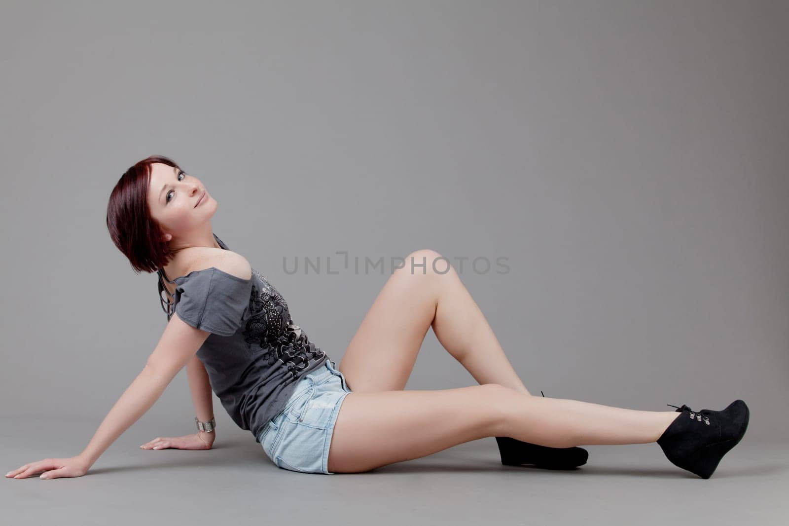attractive smiling woman. Portrait of an attractive young woman.  lady posing on grey background.
