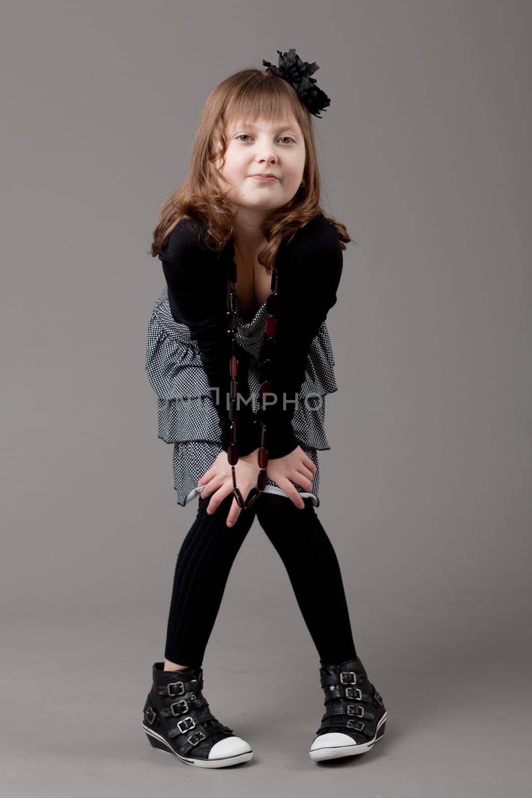 young happy girl.  little girl on a gray background