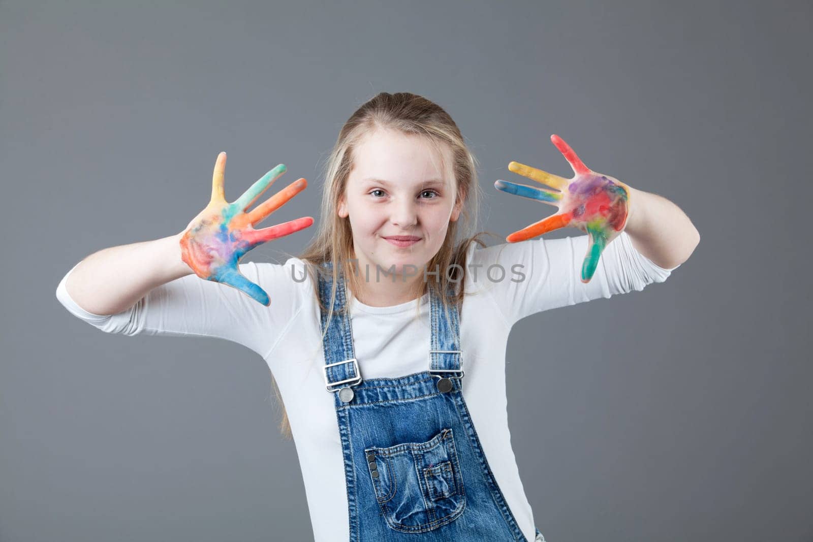 young happy girl.  little girl on a gray background