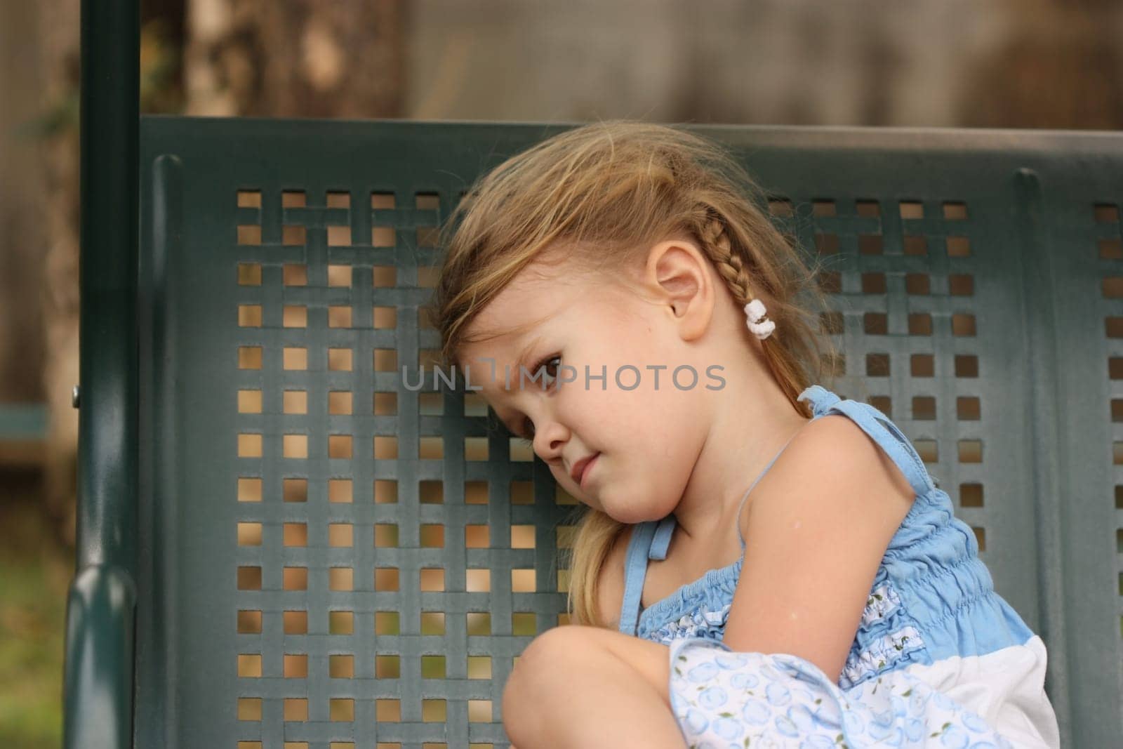 sad little child on a bench