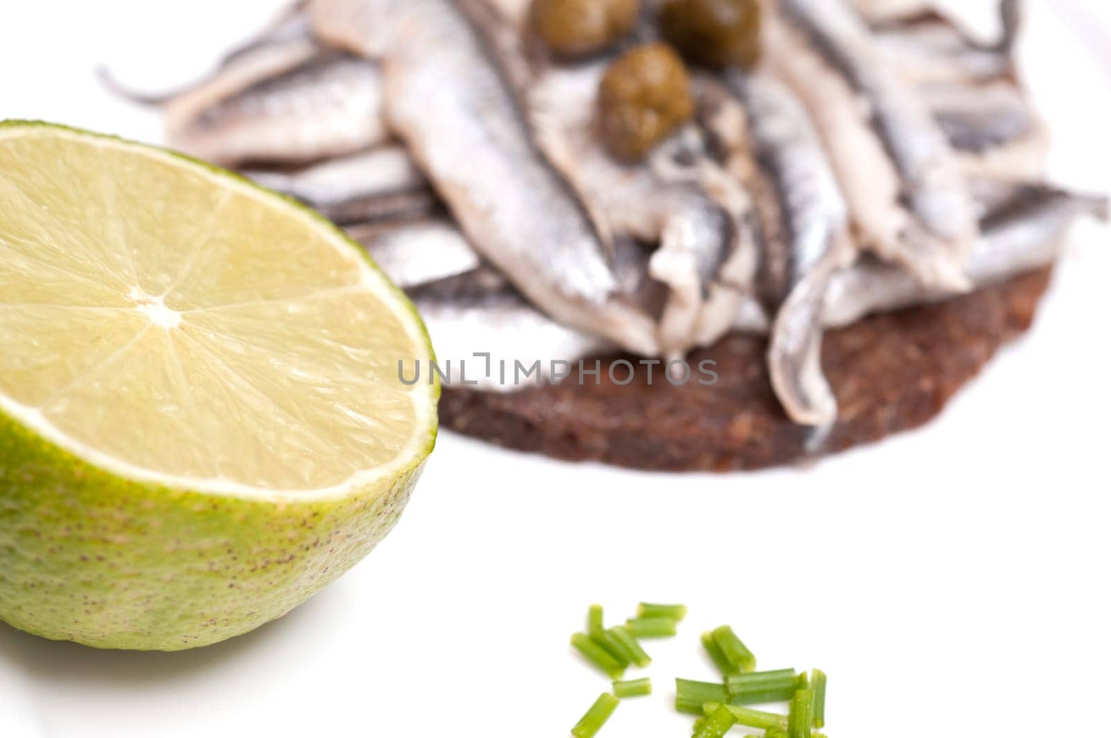 Lime and chives with canape of sardines and capers in the background