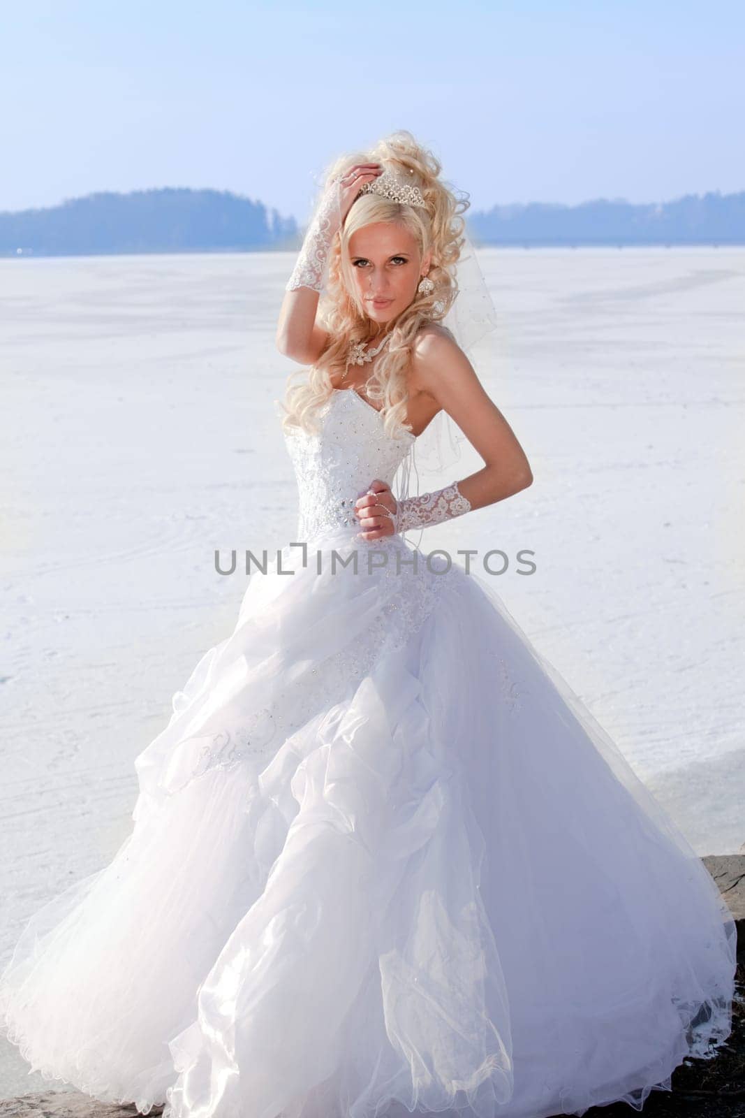 Beautiful bride in the winter forest. Beautiful blonde.