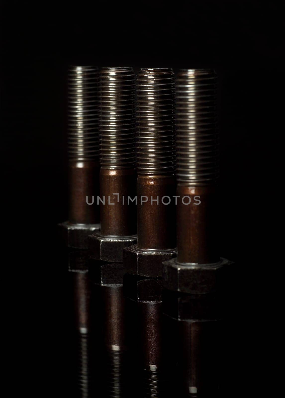 Group of screws on black background