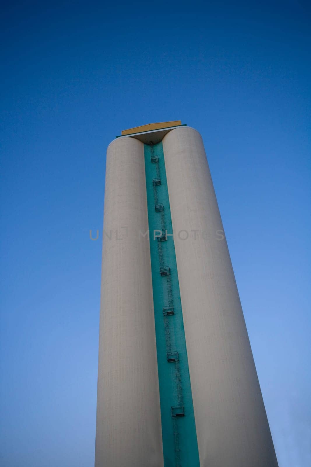 Silo towards blue sky from low angle view