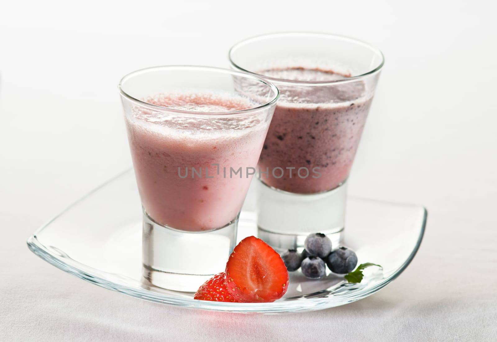 Fresh cold strawberry and blueberry smoothie close up