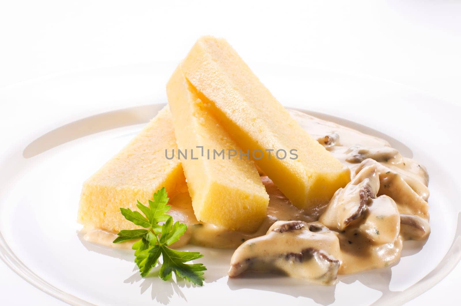 Healthy polenta with creamy mushroom sauce close up