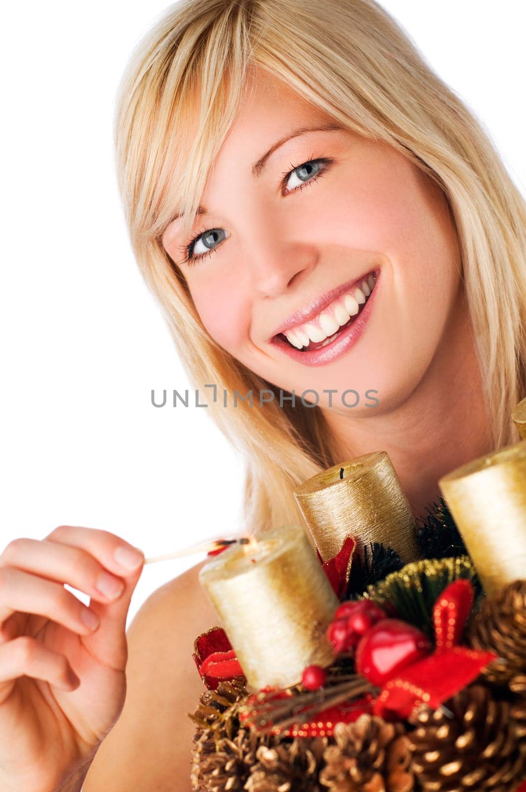 young blond girl holding advent wreath on white