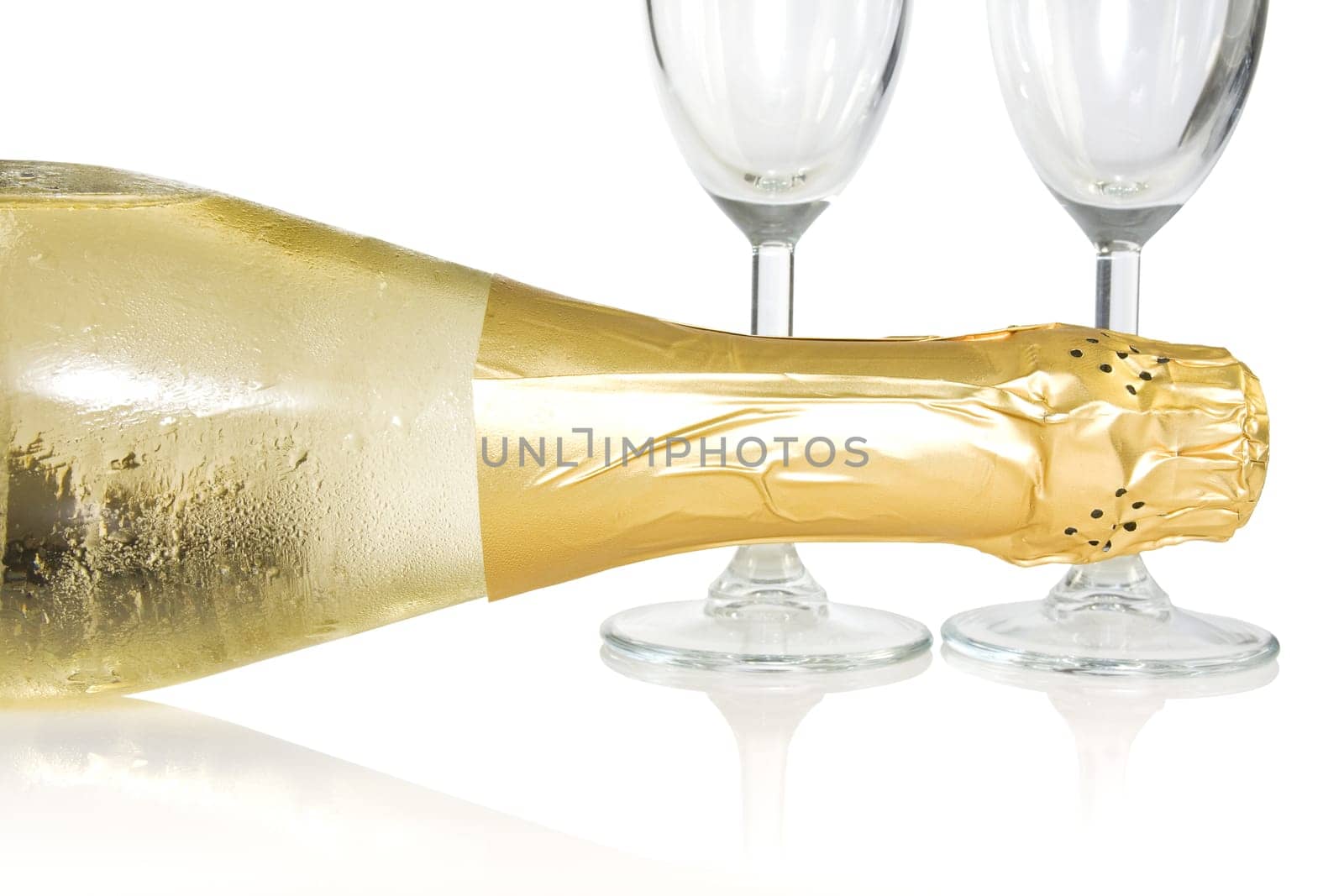 bottle and glasses of champagne over a white background