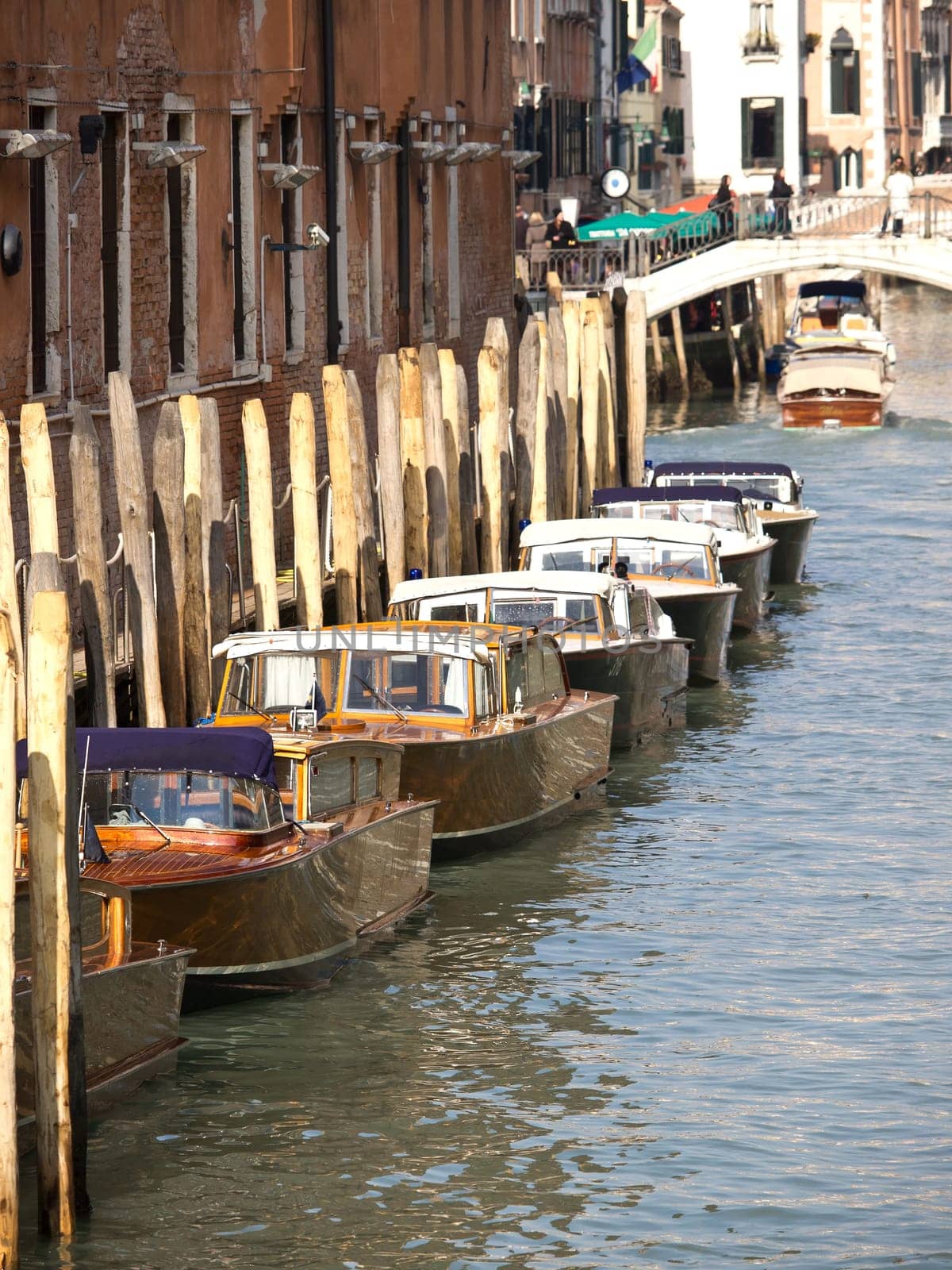 traditional wooden boats on canal in Venice