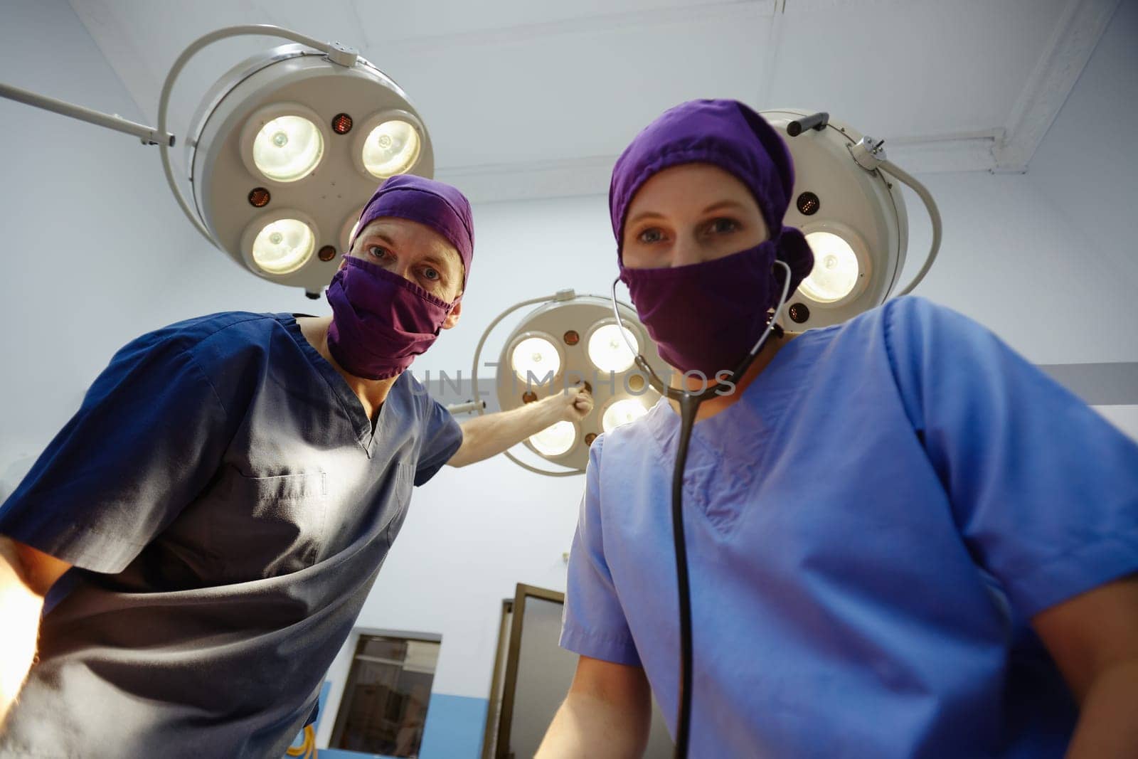 Teamwork with nurse and surgeon performing surgery in hospital operation room