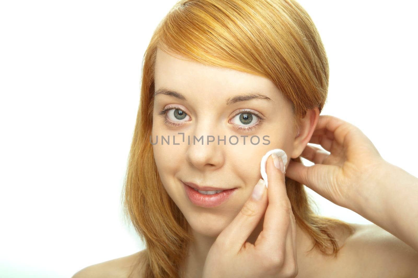 young redhead remove make up with pad