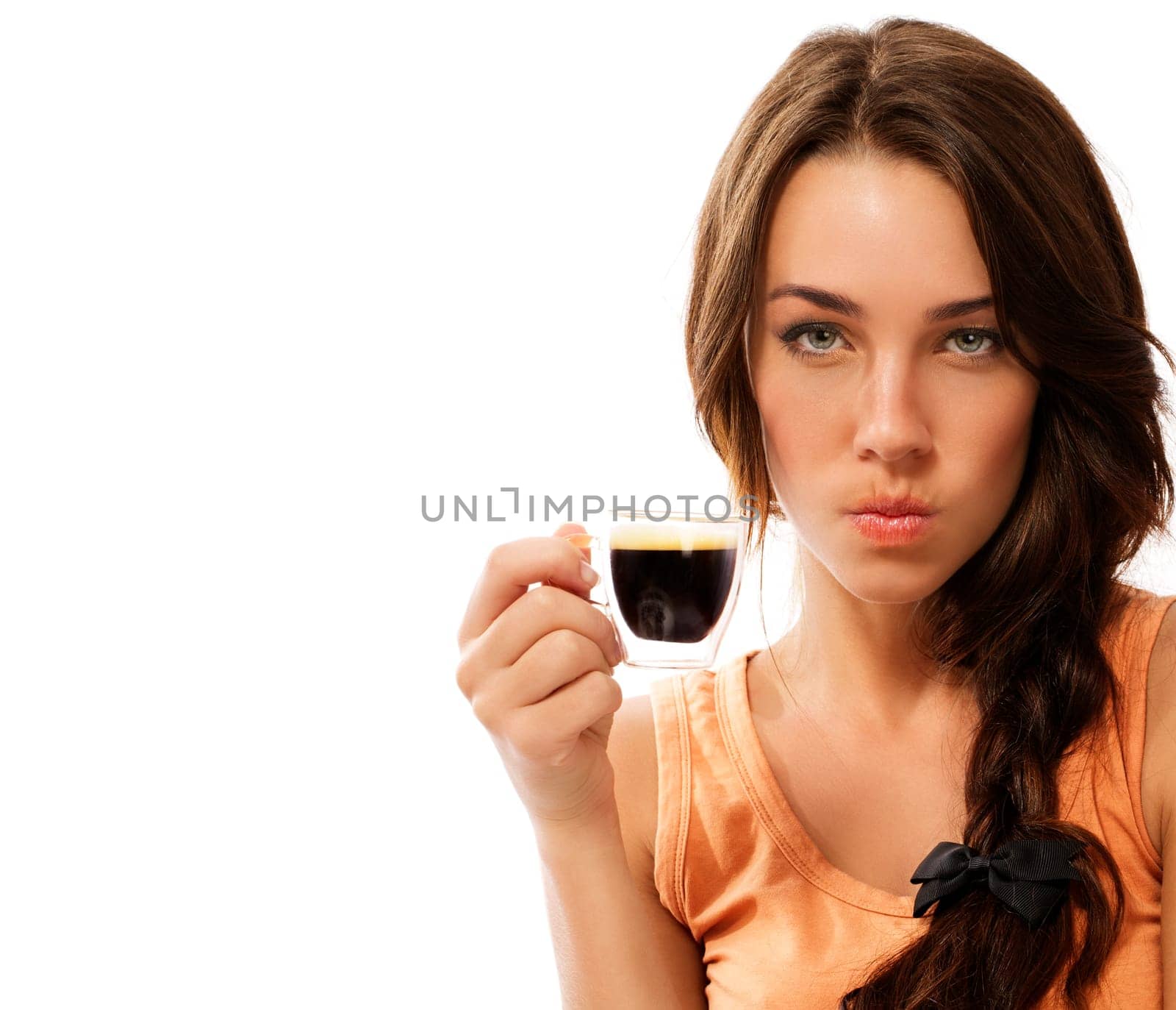 Angry young woman with a cup of espresso coffee against white background