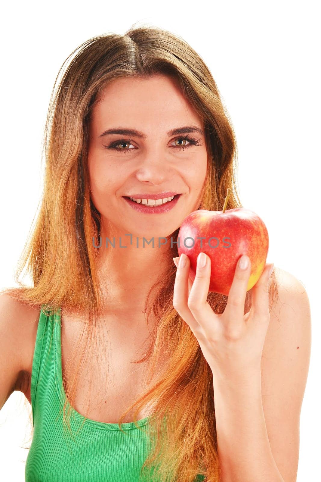 Young beautiful woman holding a red ripe apple in her hand