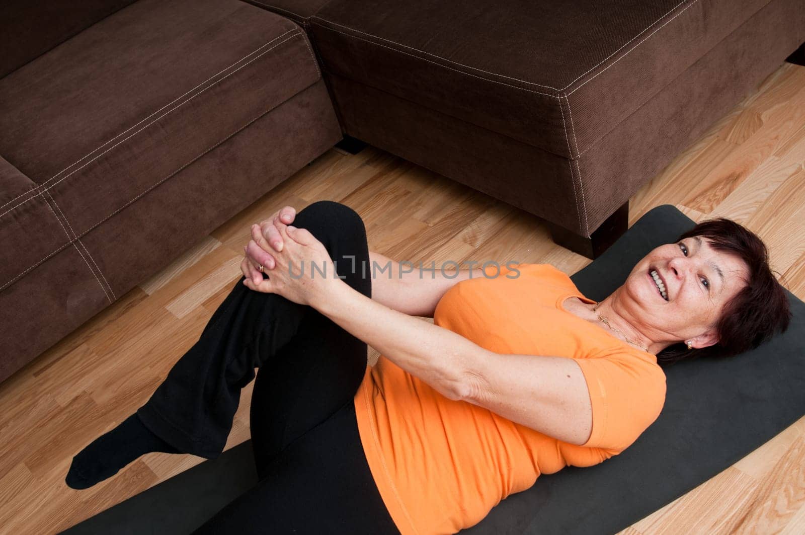 Mature fitness woman exercising at home