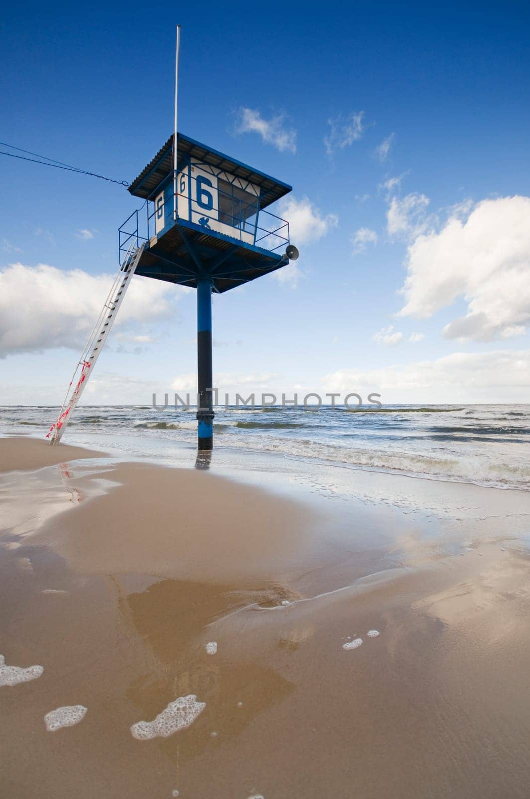 deserted Baltic Sea beach with lifeguard tower in summer as a wide-angle shot