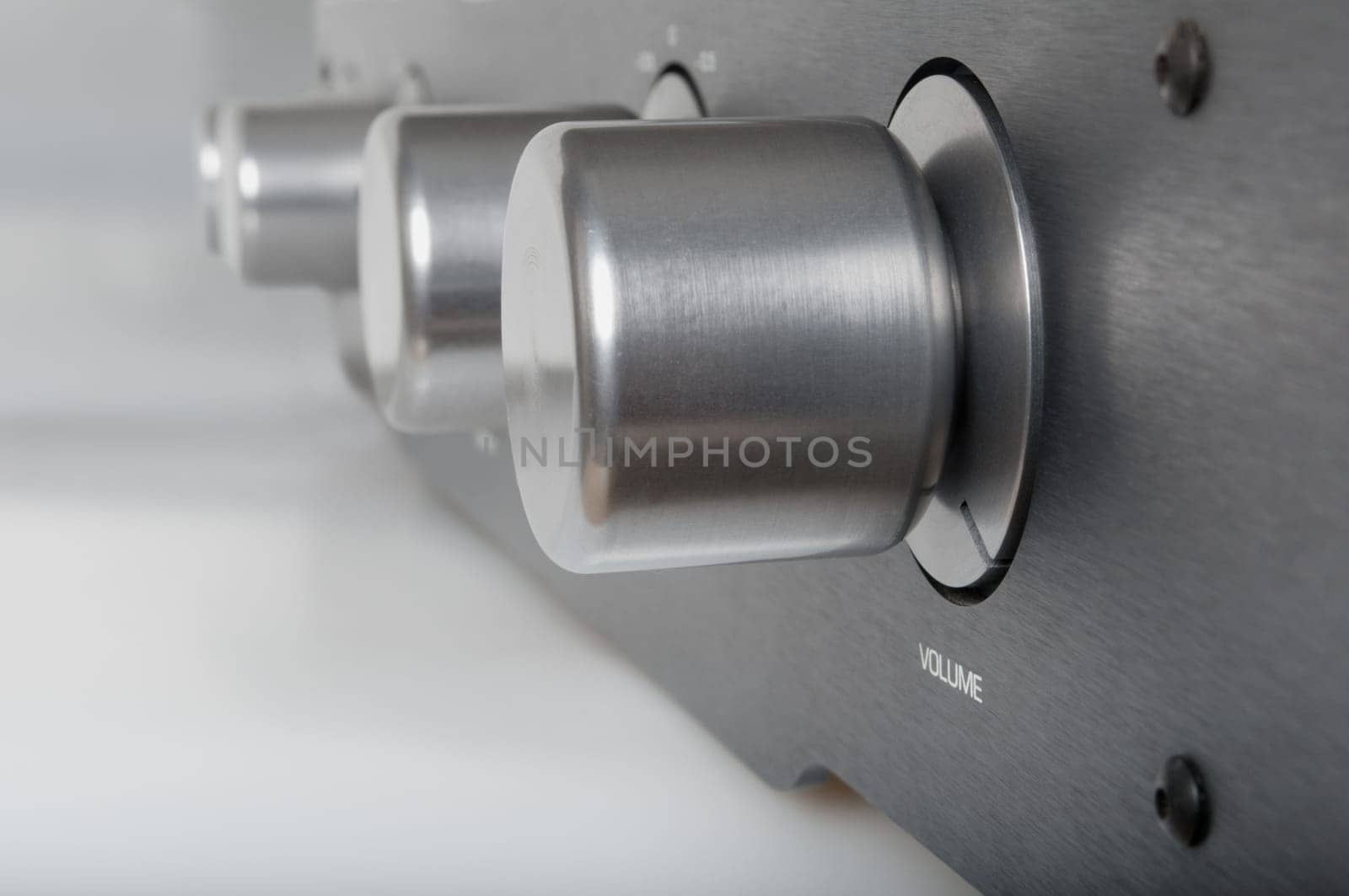 Volume Knob on Silver Metallic Amplifier - Shallow Depth of Field