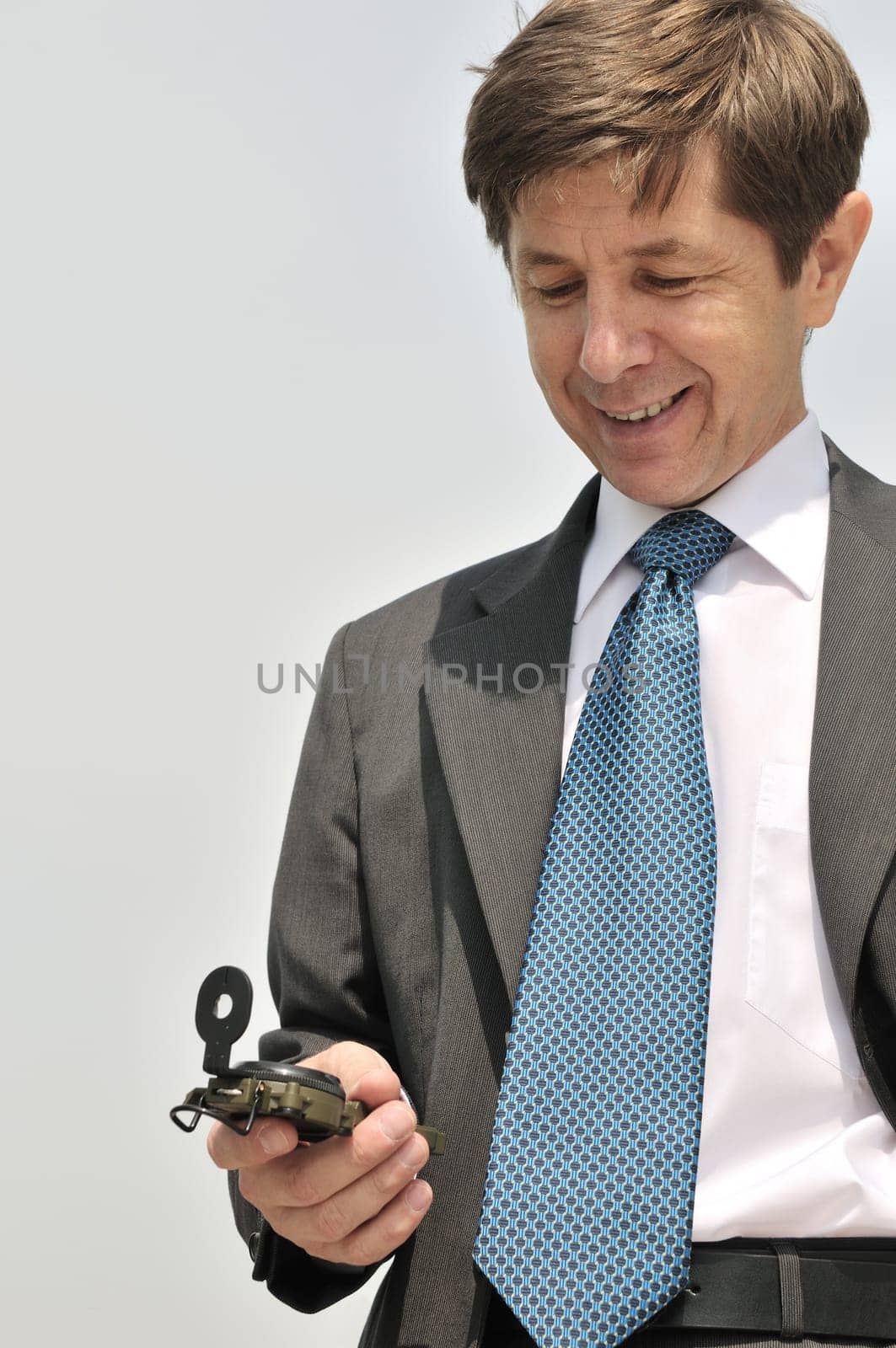 Senior people series - portrait of mature business man looking at compass with copy space