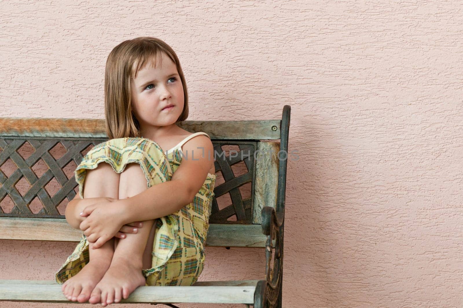 Portrait of small cute girl looking to side with copy space