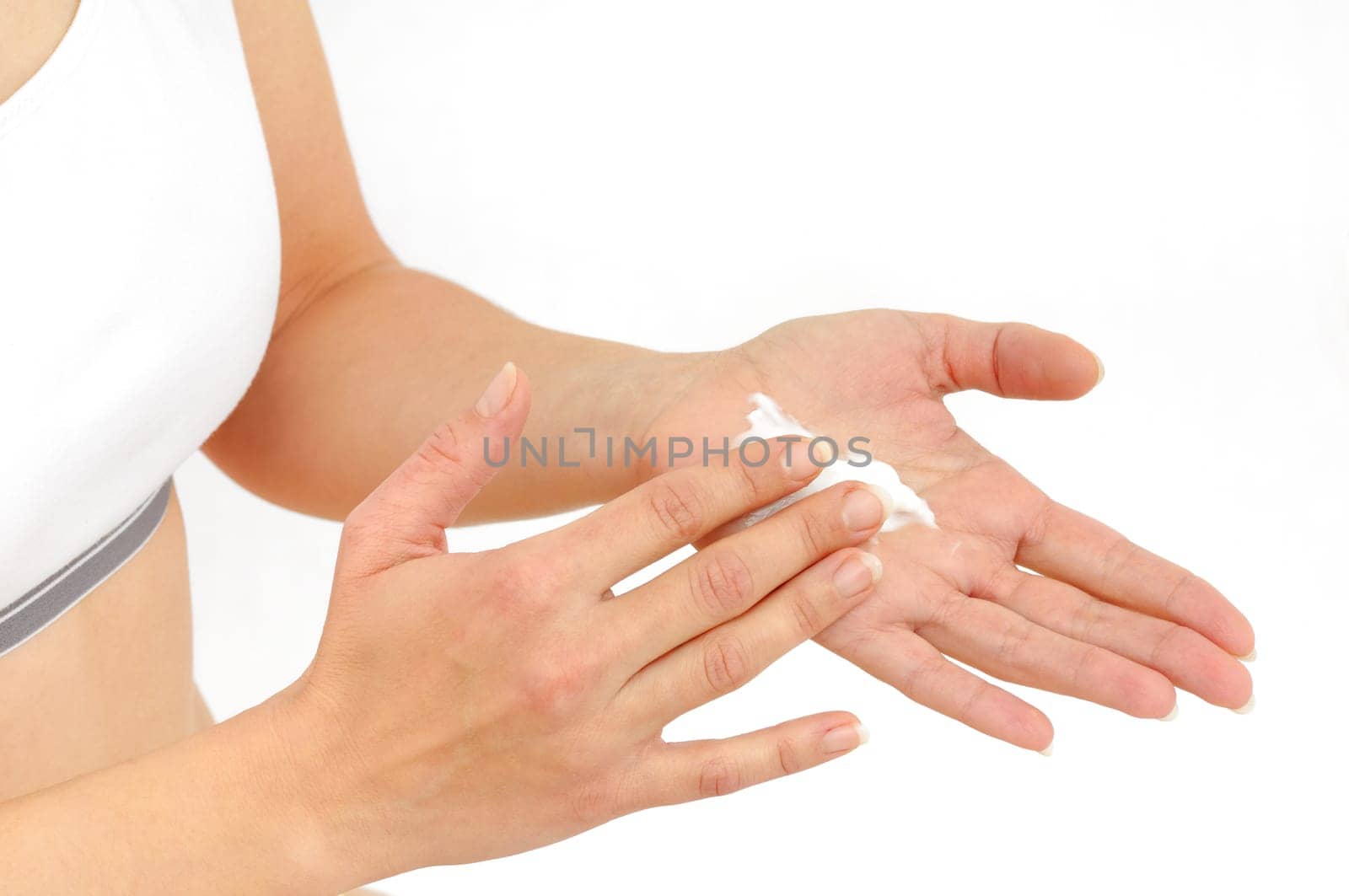 Woman in underwear applies cream on dry hands