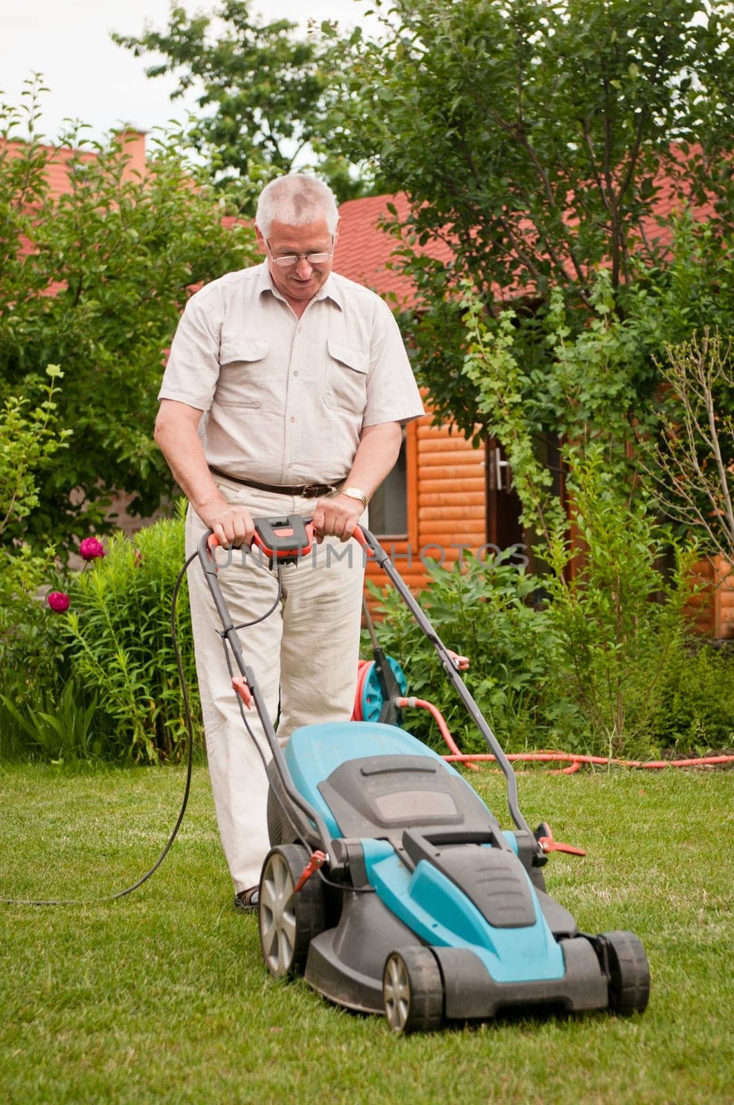Senior man with lawn mower