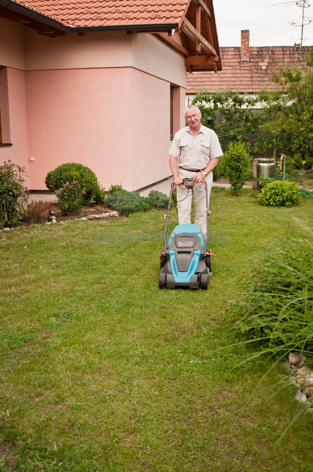 Senior man with lawn mower
