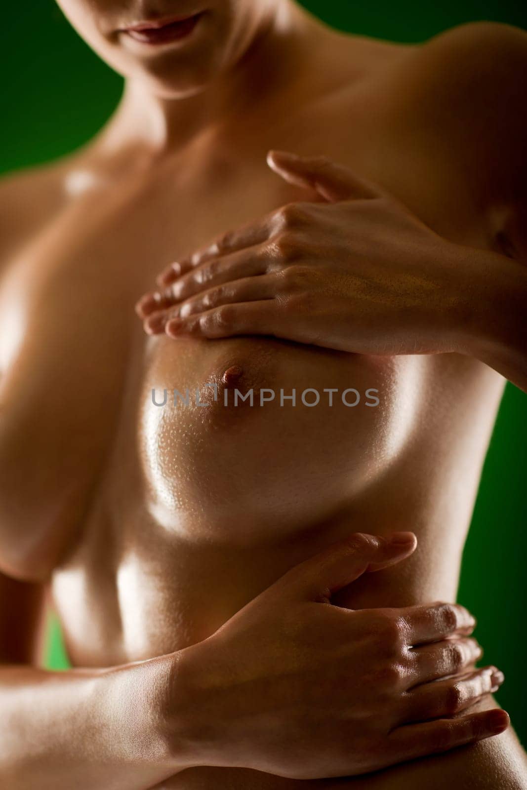 Naked woman breasts apply oil moisturizer sexy slim body
