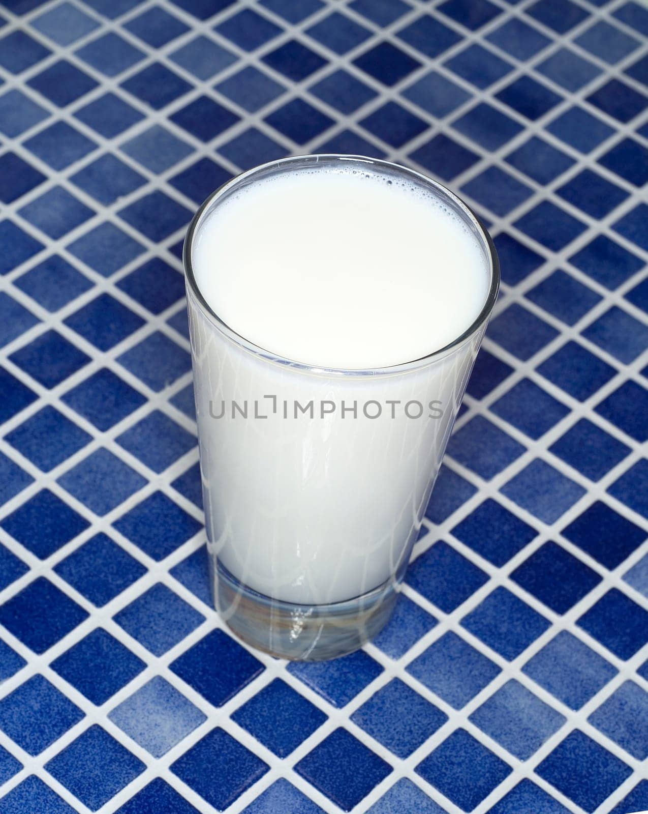 Glass of Milk towards blue mosaic