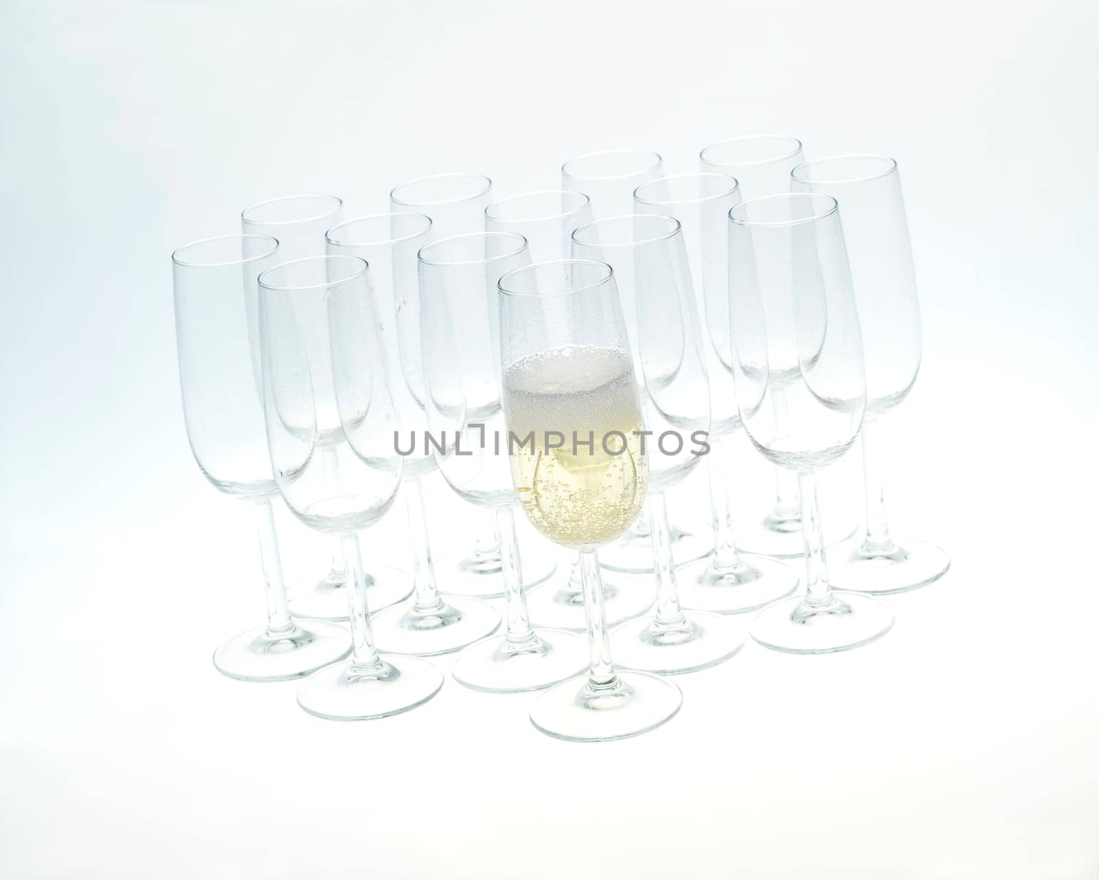 Glasses of champagne on white background