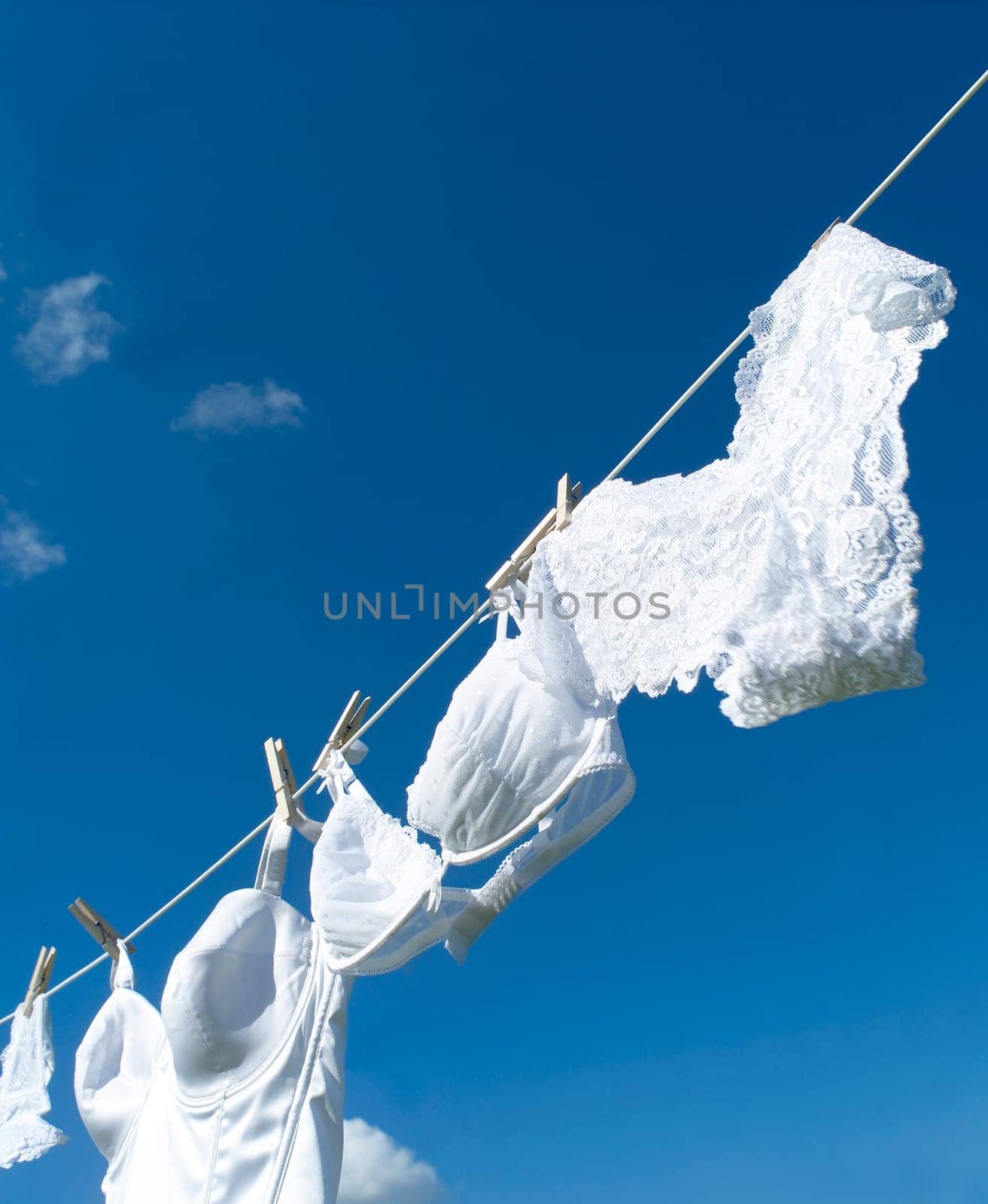 Female underwear on a clothesline towards blue sky