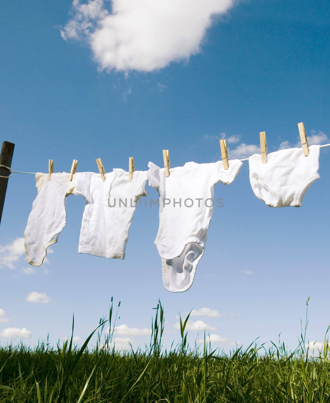 Baby Clothing on a clothesline towards blue sky