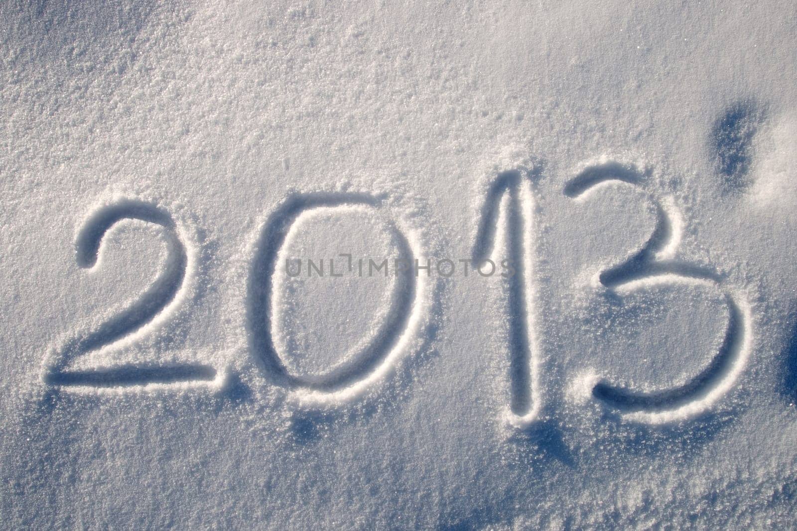 Message handwritten in fresh powdery snow for 2013