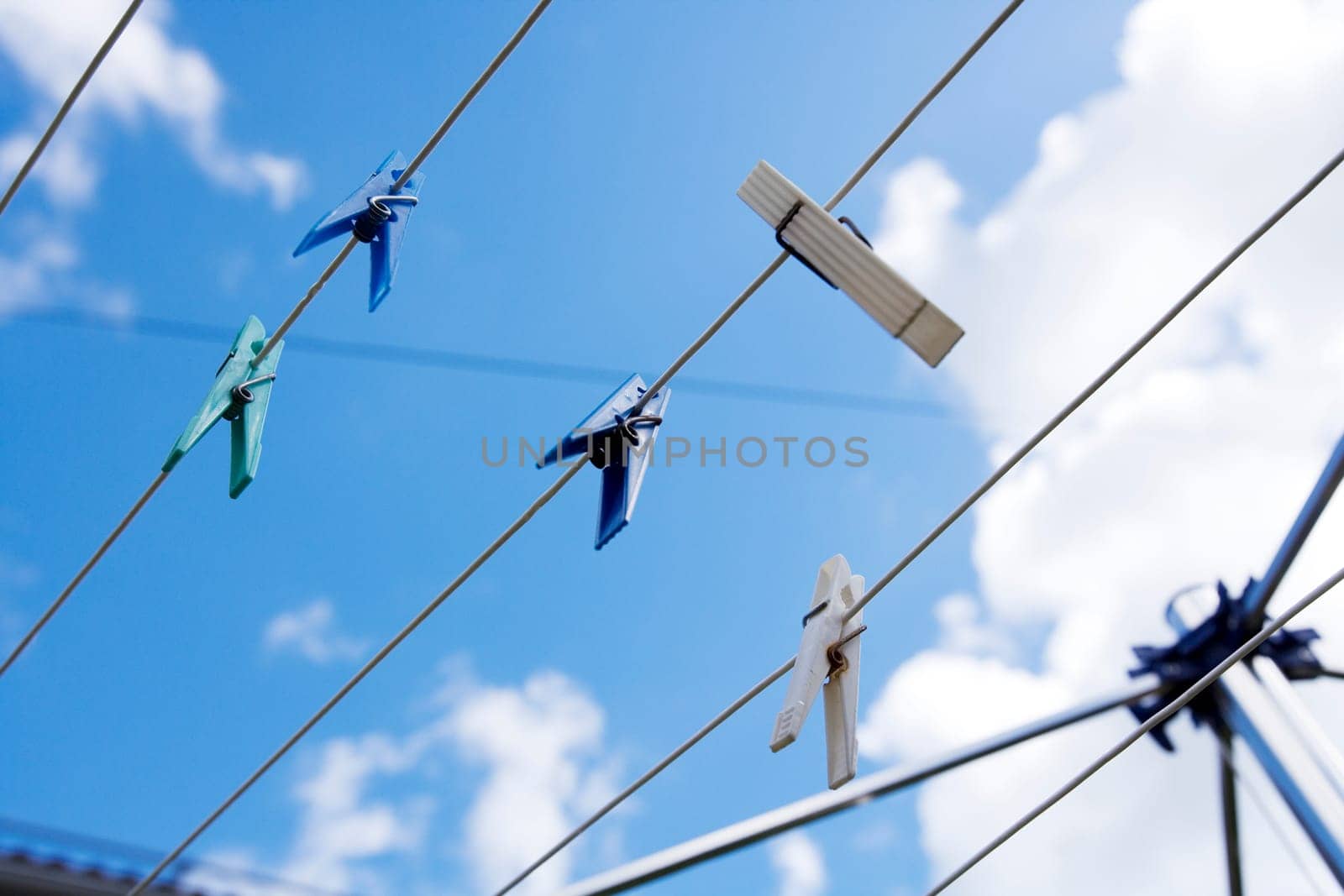 Clothespins with selective focus towards blue sky