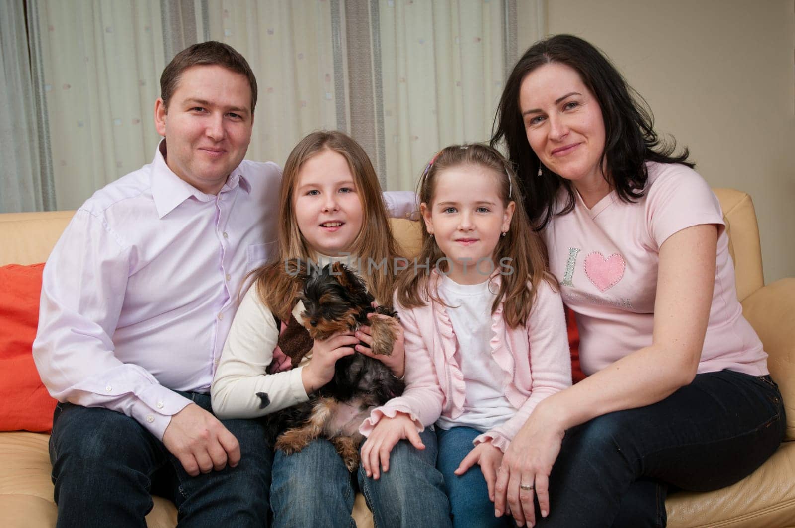 Family portrait at home - with two children and dog