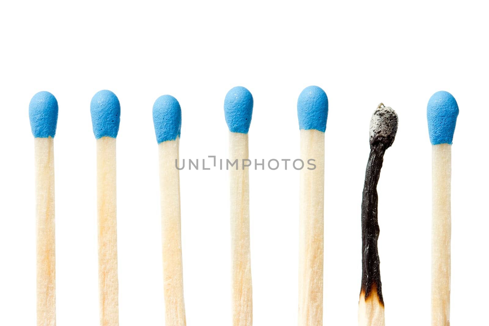 burnt match and a whole blue matches isolated on a white background