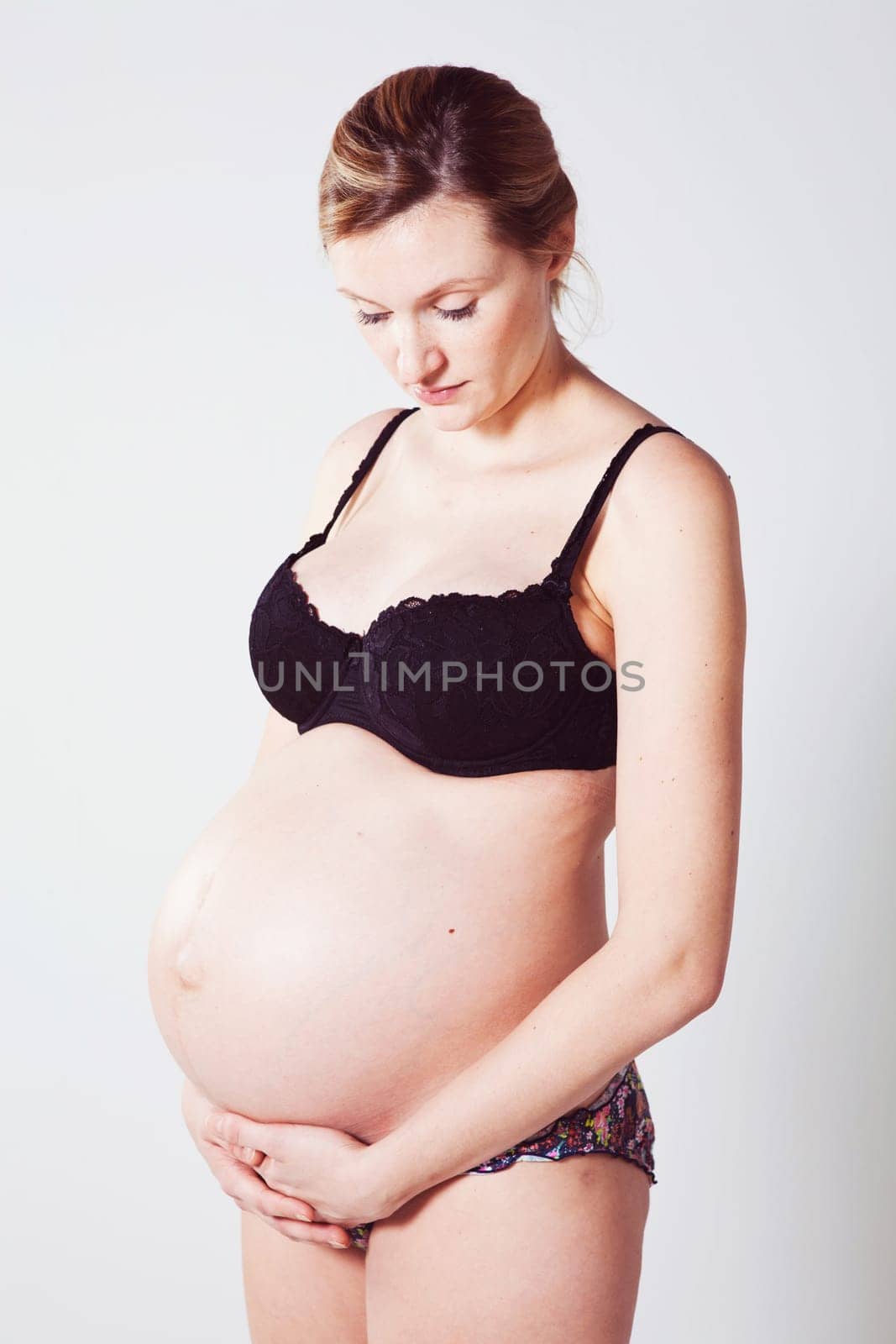 Portrait of a beautiful pregnant mother. Studio shot.