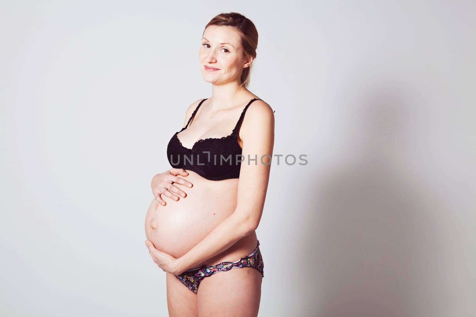 Portrait of a beautiful pregnant mother. Studio shot.