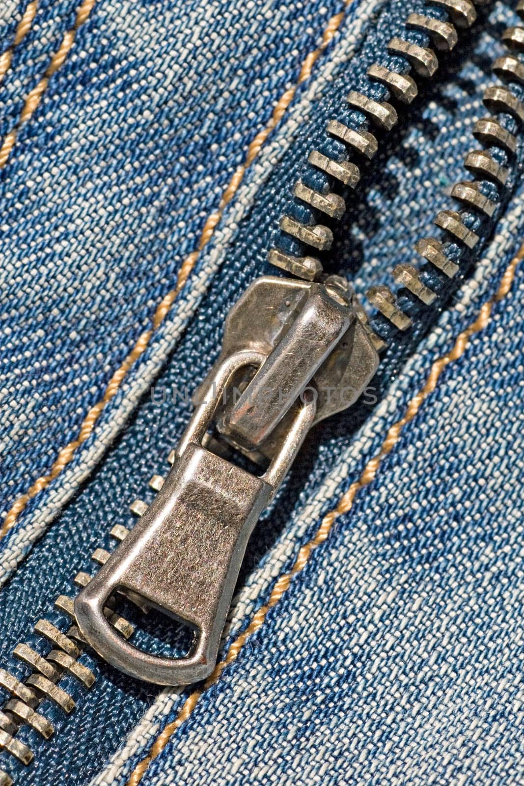 closeup of the zipper of a stylish blue jeans