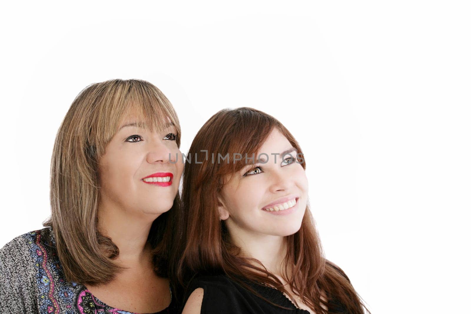 Mother and young daughter looking away
