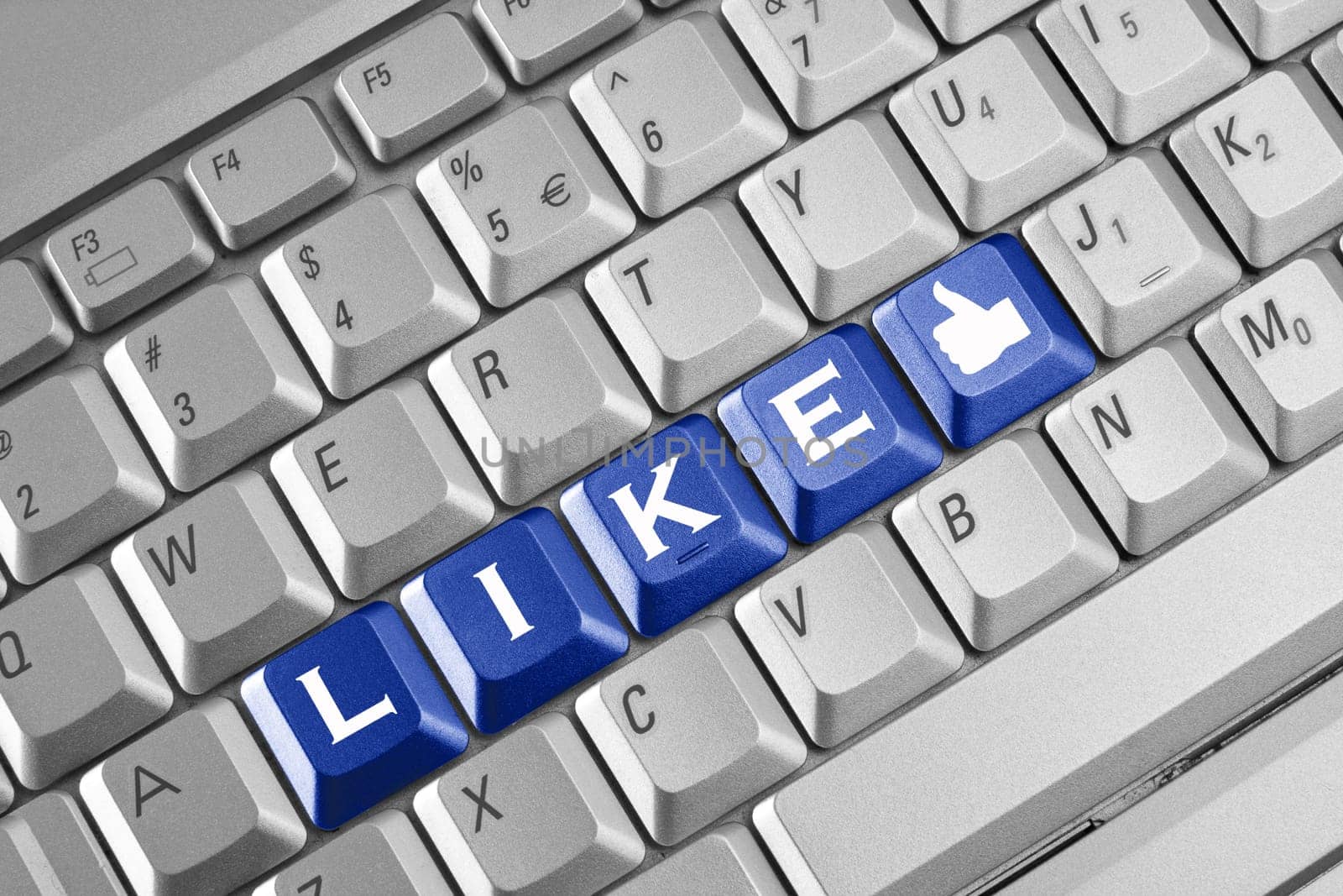 Social network concept . Keyboard with blue Like button.