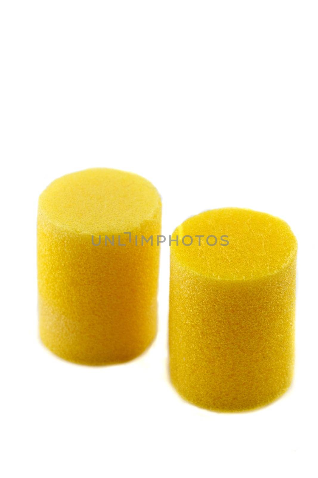 yellow ear plugs on a white background