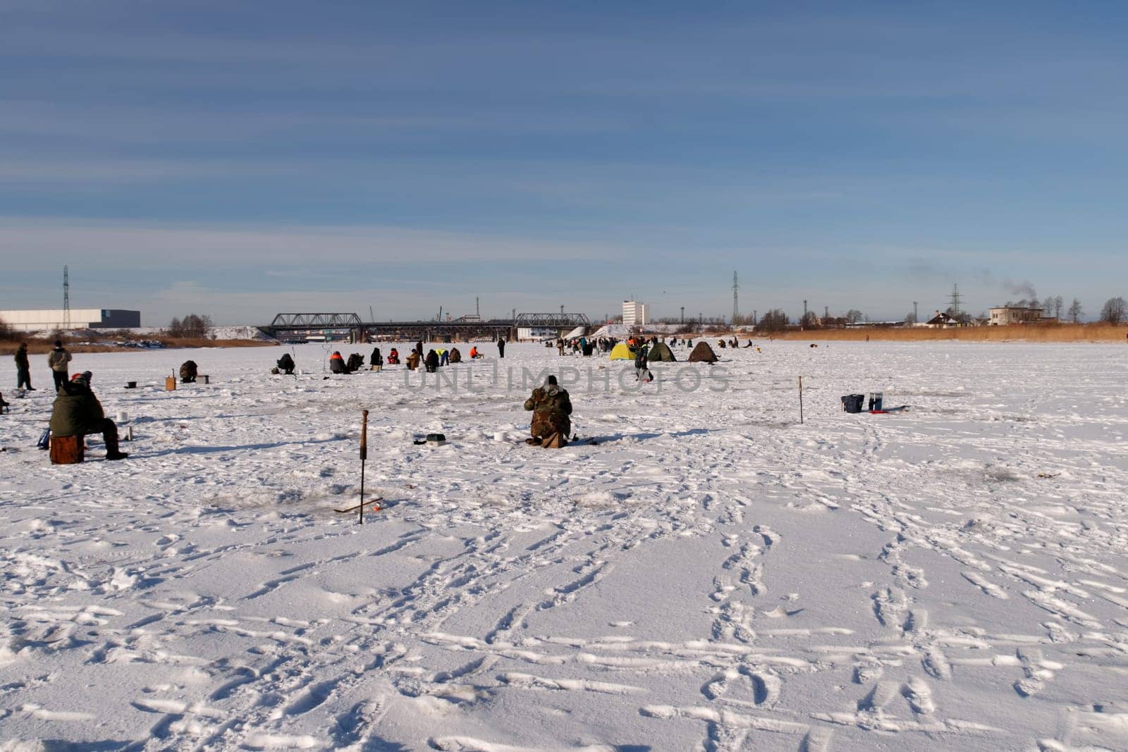 ice fishermens fishing on a frozen river
