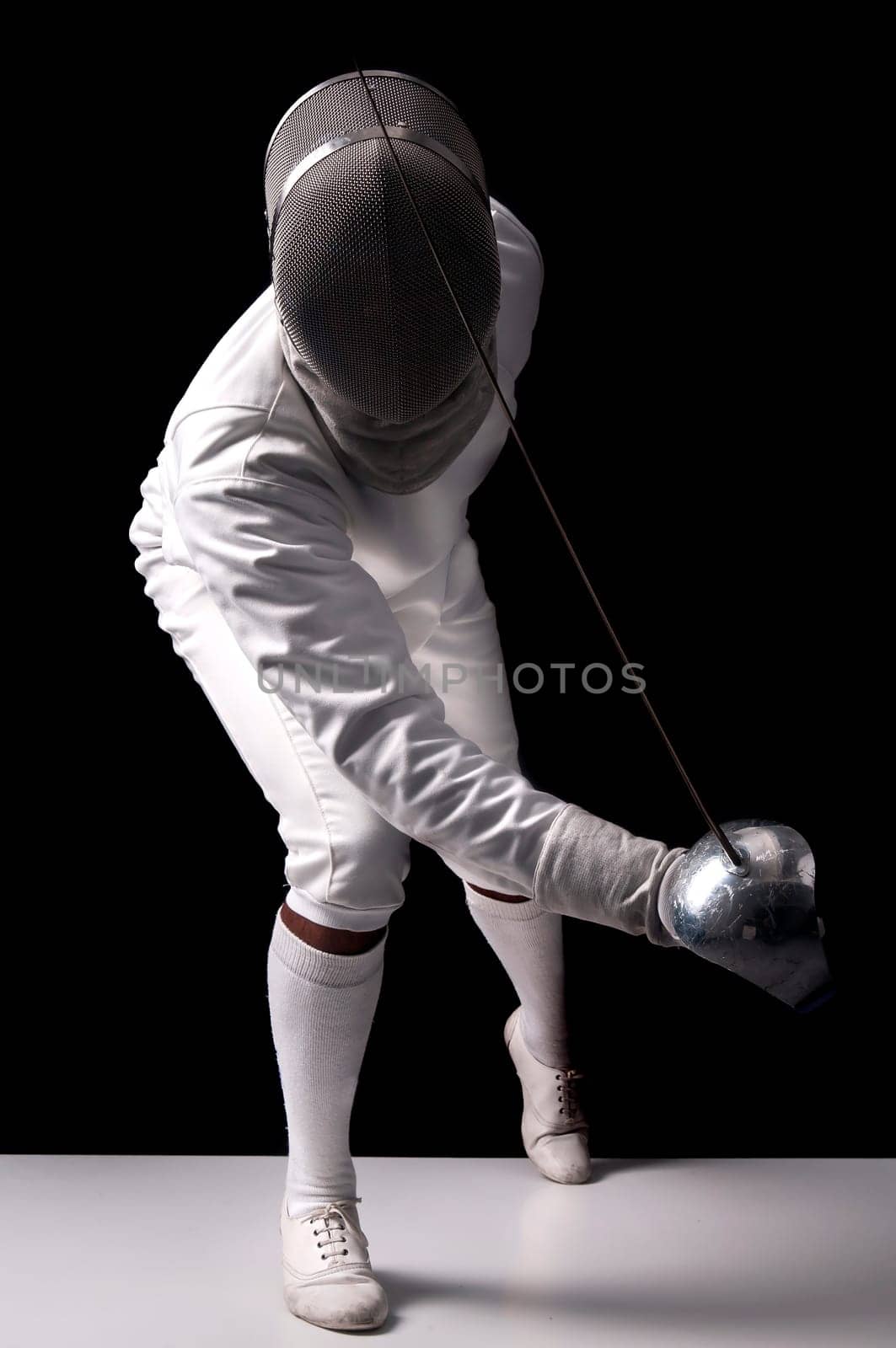 Male fencer isolated in a dark background