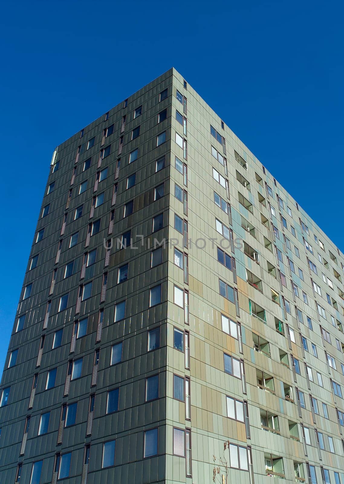 Skyscraper in sunlight towards blue sky