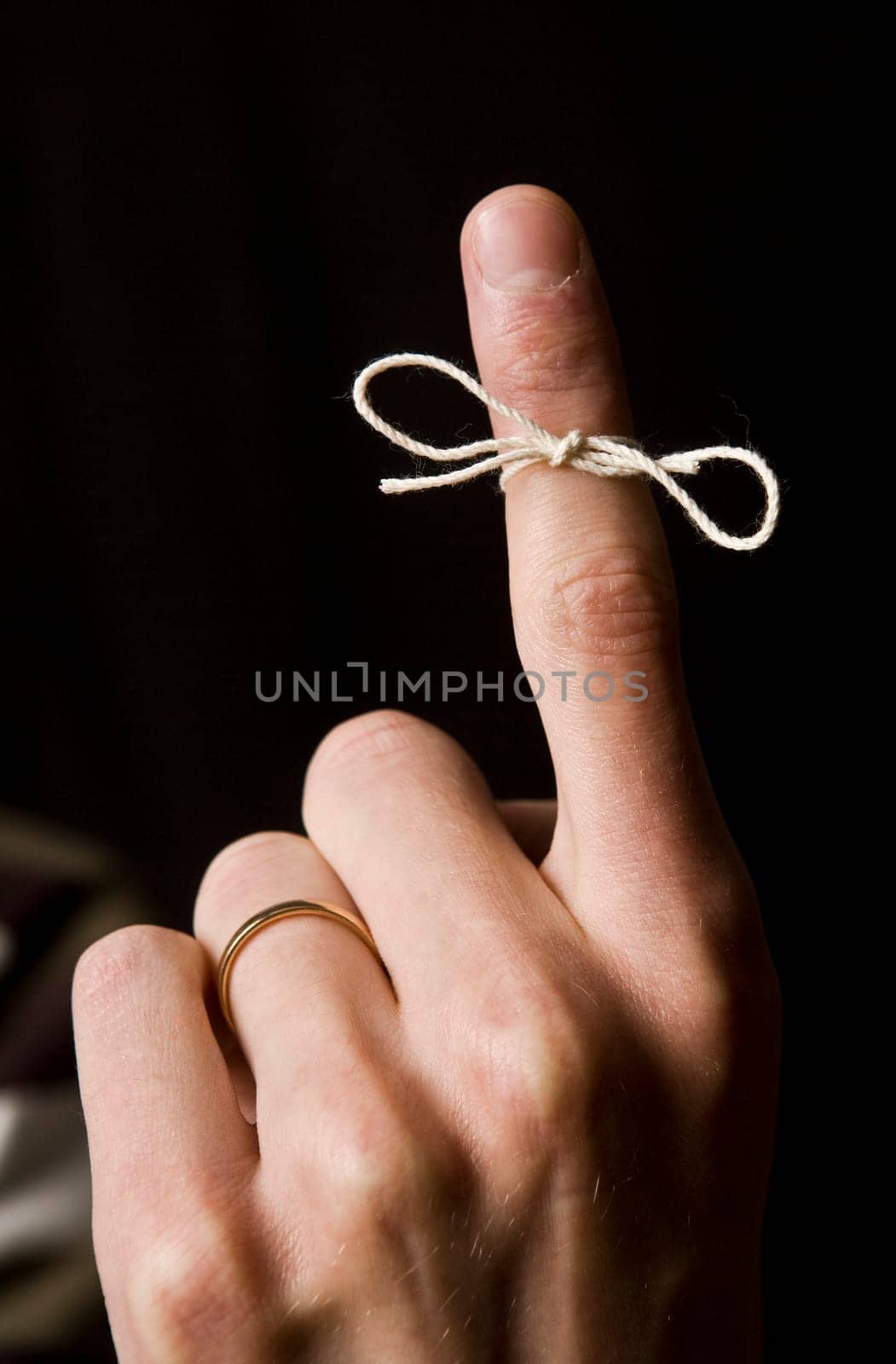 Reminder on the finger isolated on Black background