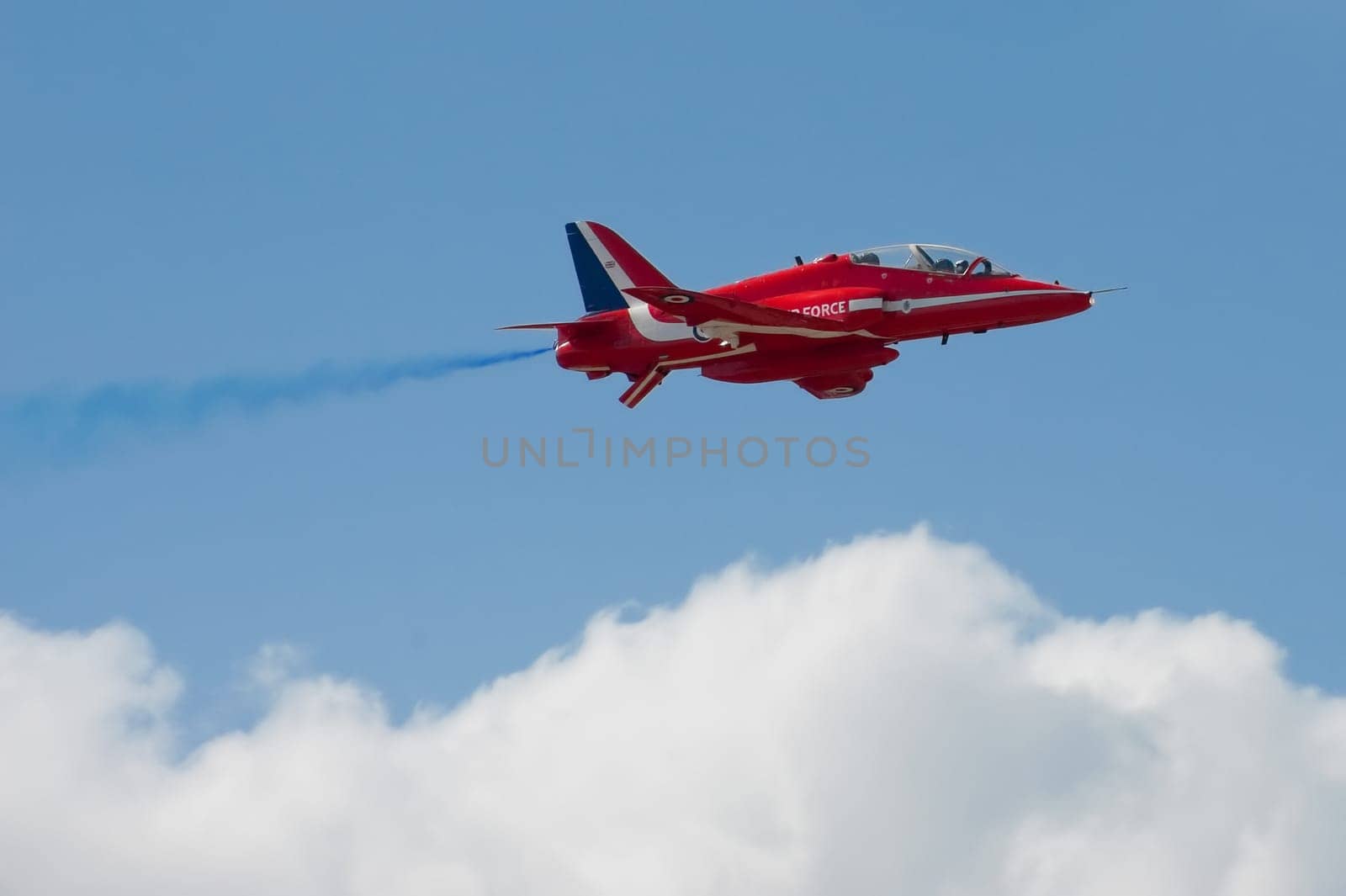 Low level pass by a Red Arrows aerobatic display jet during pre-show practice for the Farnborough International Airshow, July 15, 2010, UK