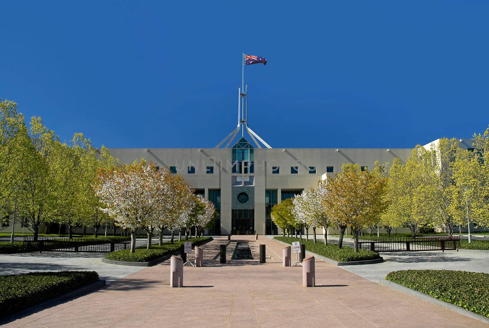 Parliament House in Australian capital city Canberra, waving flag