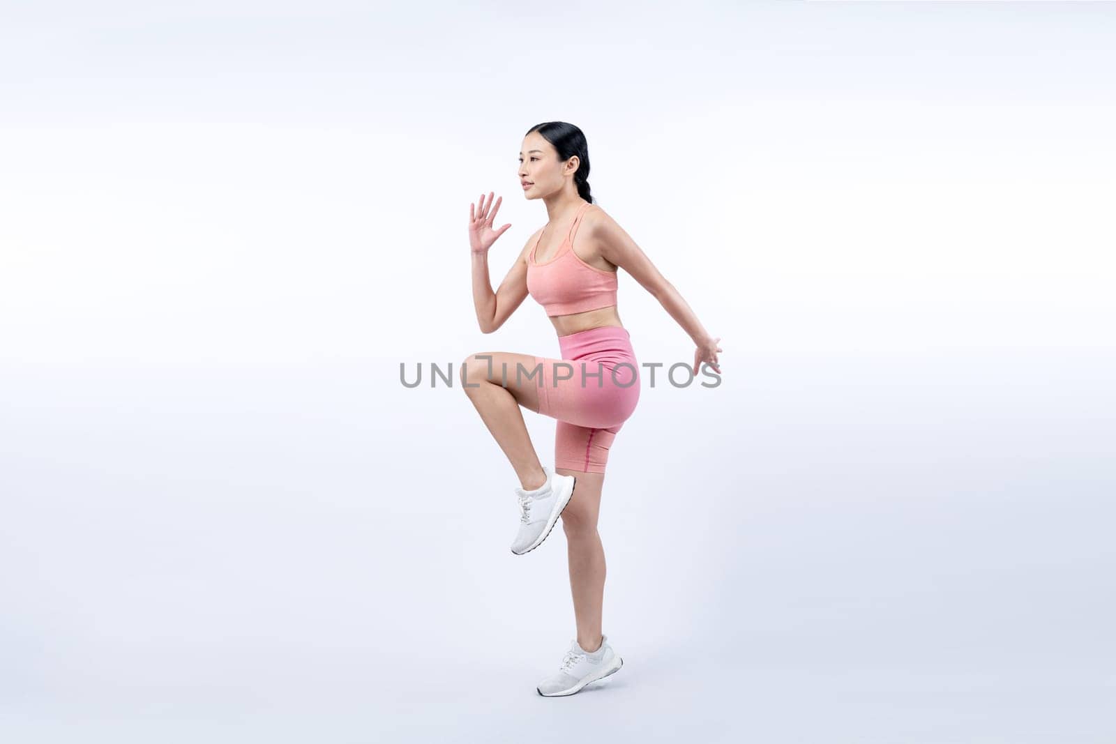 Side view young athletic asian woman on running posture. Vigorous by biancoblue