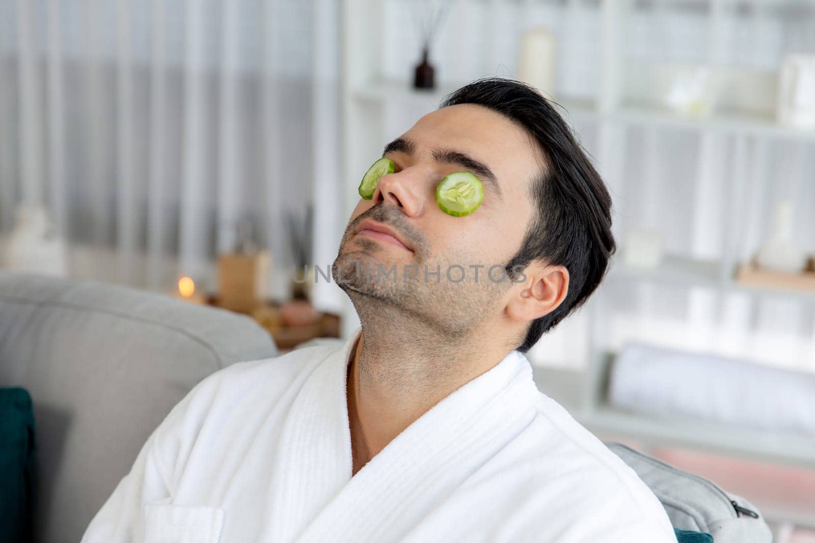 Man customer indulges in rejuvenating with cucumber facial care Quiescent by biancoblue