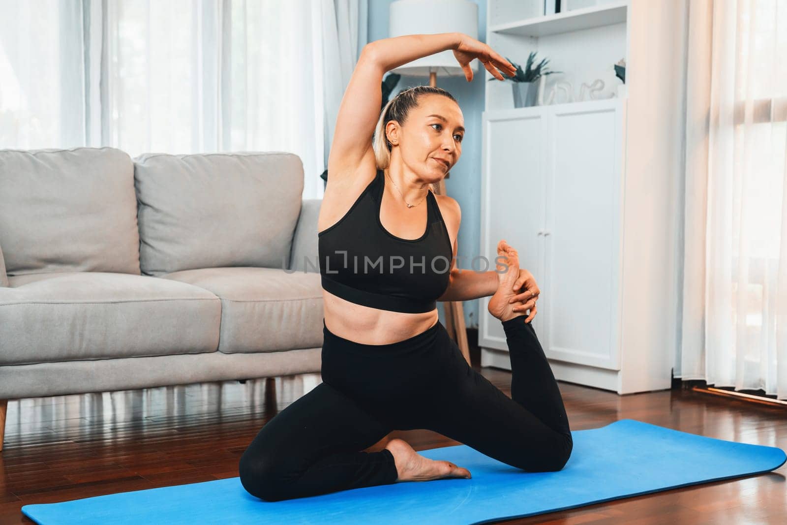 Happy active senior woman in sportswear doing yoga. Clout by biancoblue